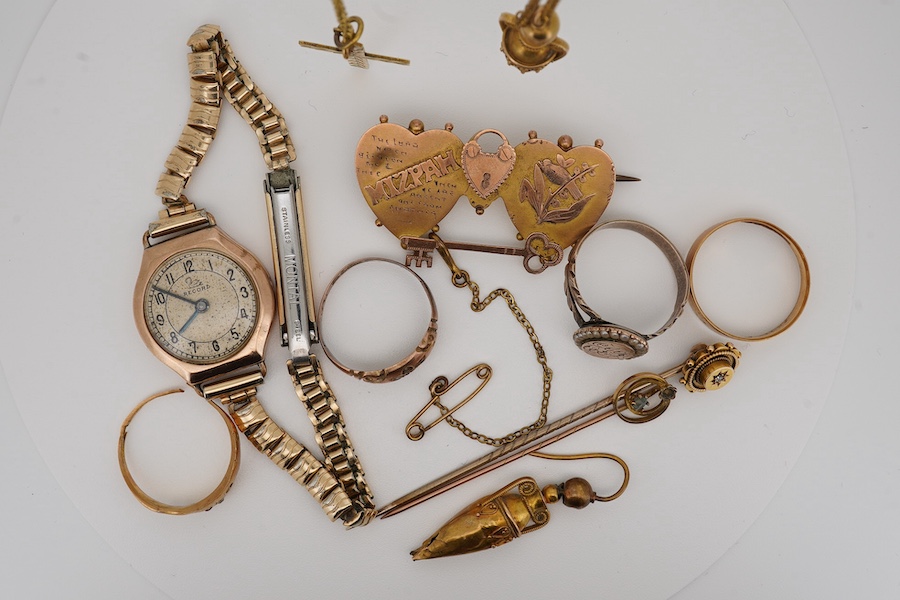 A group of jewels, comprising: a late 19th century 'Mizpah' brooch, stamped 9CT; a 9ct gold ring, British hallmark; a ruby and diamond ring, partial British hallmarks; a diamond stick pin, stamped 15CT, an aquamarine sti